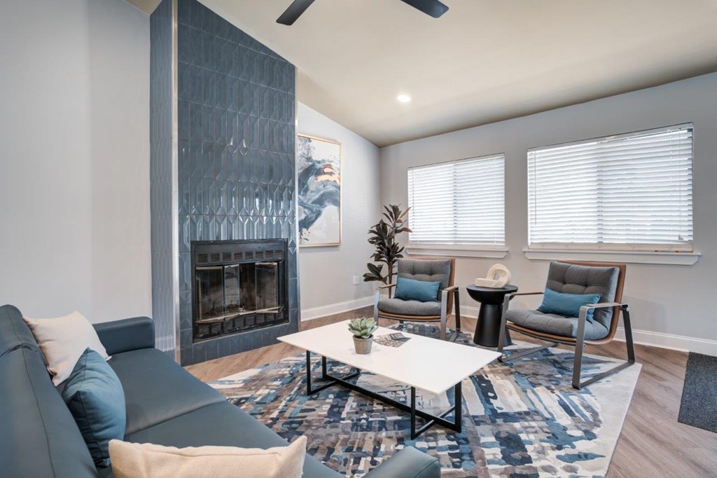 A modern living room with a fireplace and a grey couch.