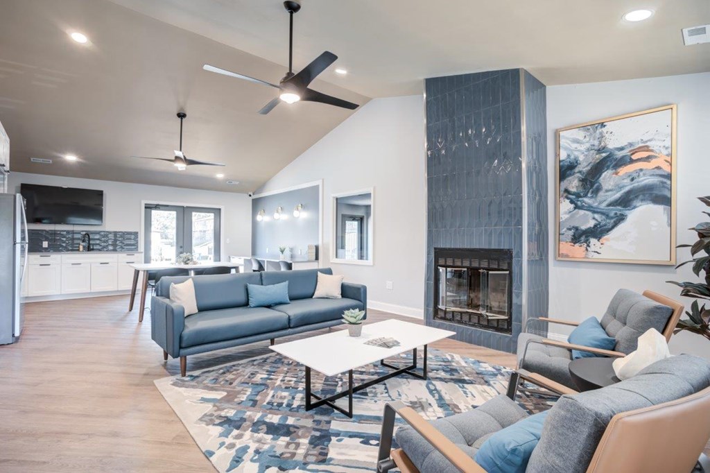 A modern living room with a grey sofa, a coffee table, and a fireplace.