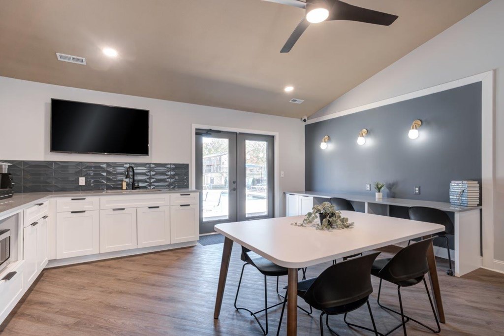 A modern kitchen with a dining table and chairs.