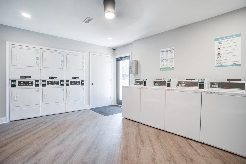 A bank with a white interior and a row of ATMs.