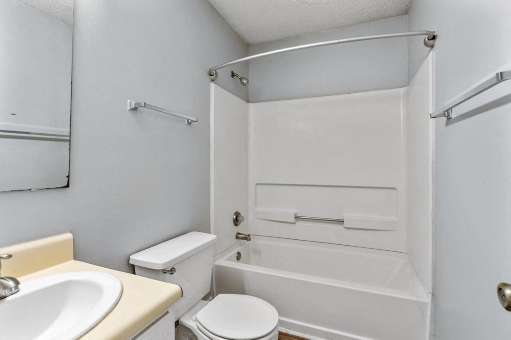 a bathroom with a sink toilet and a bath tub