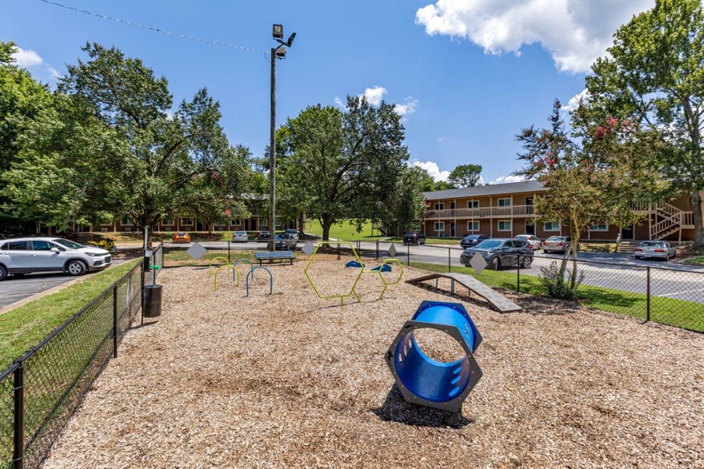 a playground at a park with a blue swing set