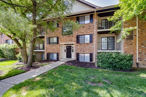 A brick building with a tree in front of it.