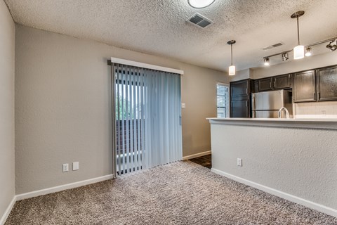 A kitchen area with a counter and cabinets.