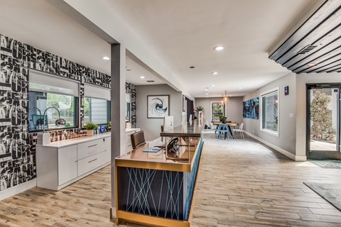 A modern kitchen with a wooden table and chairs.