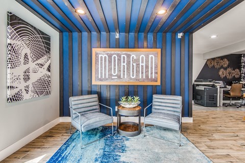 A blue and white striped room with a table and two chairs.