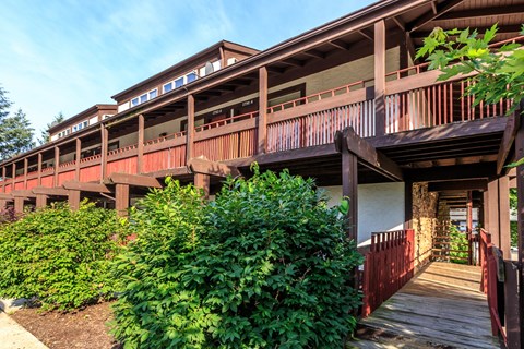 A building with a balcony and a wooden walkway.