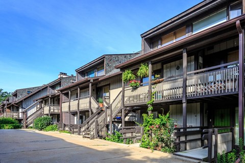 A row of wooden buildings with balconies and staircases.