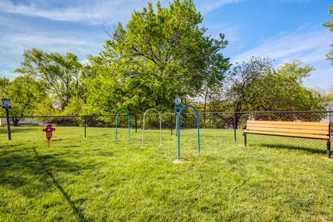 A park with a playground and a bench.