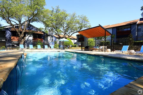 A large swimming pool with a blue tarp around it.