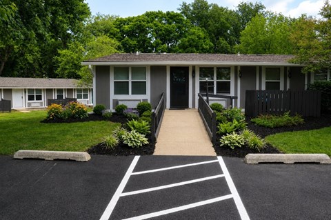 A house with a driveway and landscaping in front.