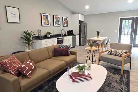 A living room with a couch, chairs, and a coffee table.