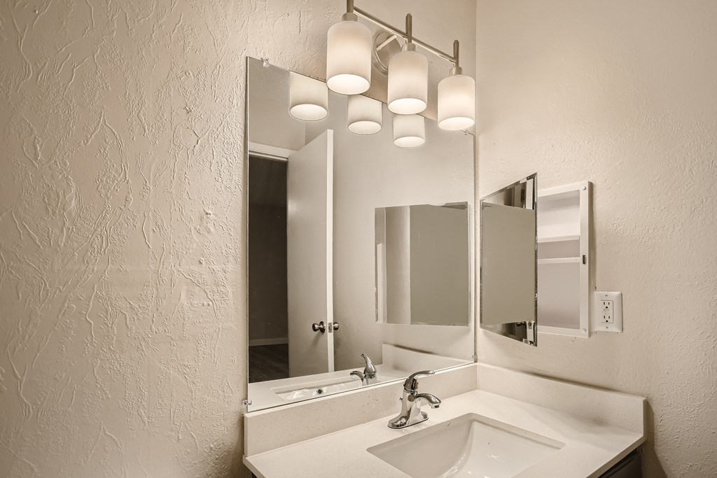 A bathroom sink with a mirror above it.
