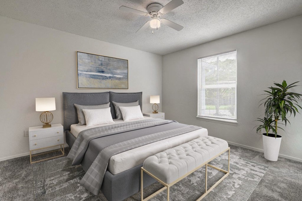 a bedroom with a bed and a ceiling fan