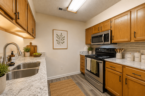 A kitchen with wooden cabinets and a stainless steel sink.