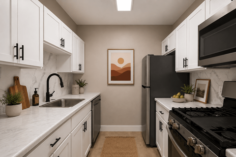 A kitchen with white cabinets and a black stove top oven.