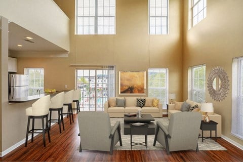 a large living room with a couch and chairs and a dining table