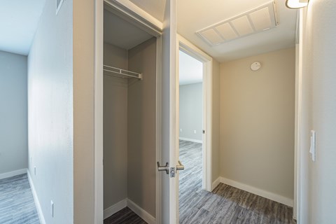 A white door is open to a room with a light on the ceiling.