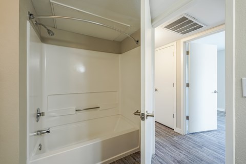 A white bathroom with a walk in shower.