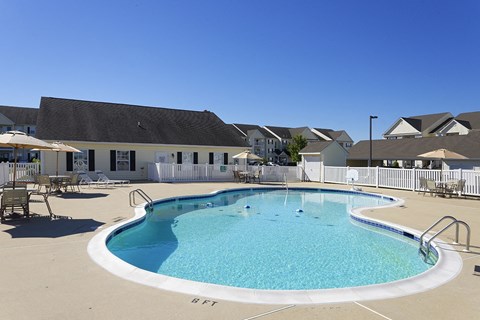 our resort style swimming pool is in front of our building and has tables and chairs