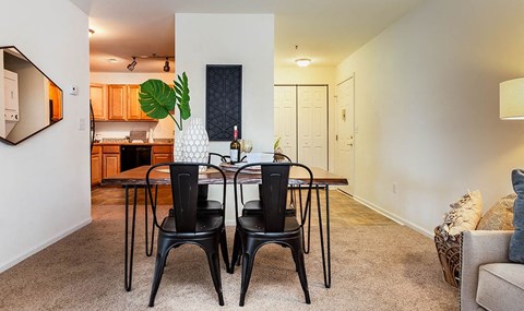 a dining room with a table and chairs