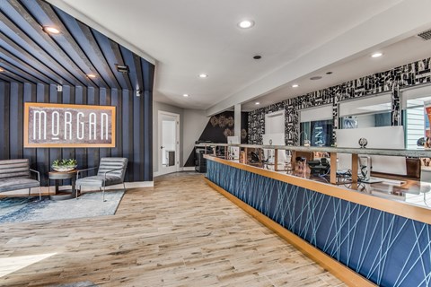 A reception area with a wooden floor and a blue wall.