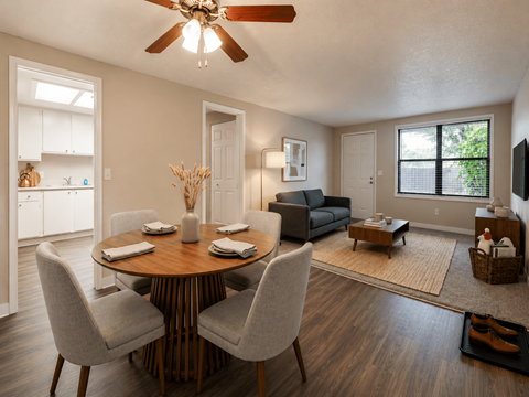 A dining room with a round table and chairs.
