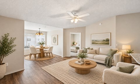 A living room with a couch, chairs, and a coffee table.
