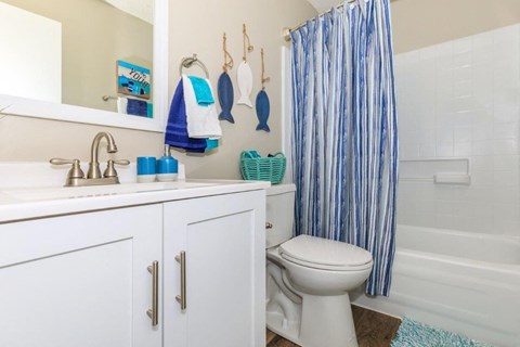 a bathroom with a shower and a toilet and a sink