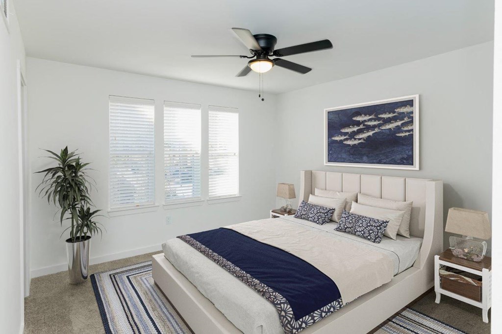 a bedroom with a bed and a ceiling fan