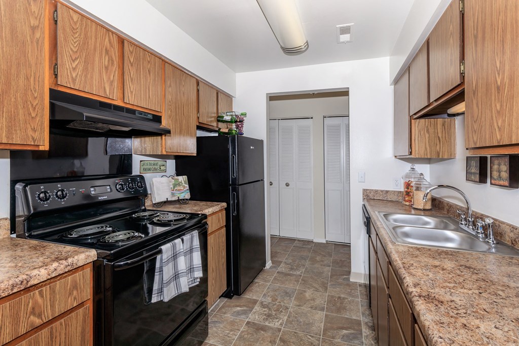 Kitchen with Black Appliances and Granite Countertops with Oak Cabinets