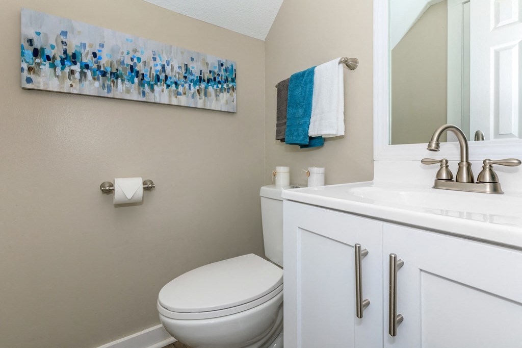 Bathroom with a toilet and a sink and a mirror