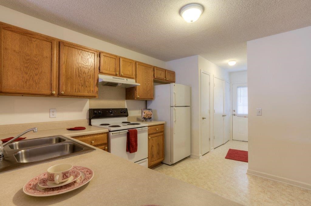 a kitchen with a sink and a refrigerator