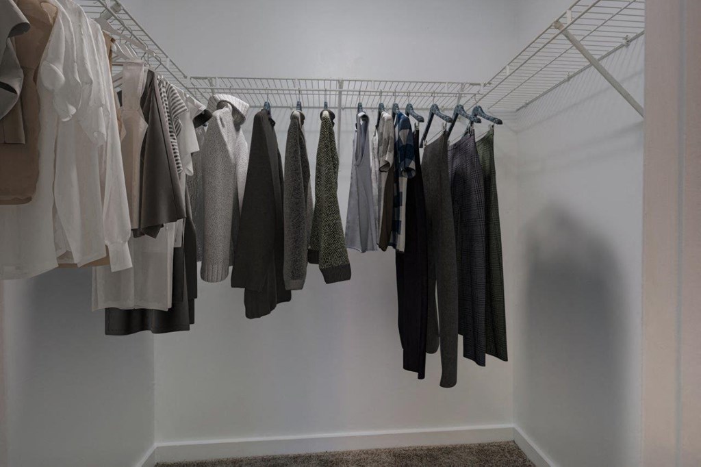 a rack of clothes hanging in a closet