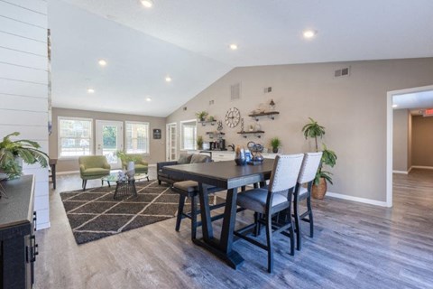 a dining room and living room with a table and chairs
