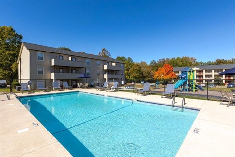 a swimming pool with a building in the background