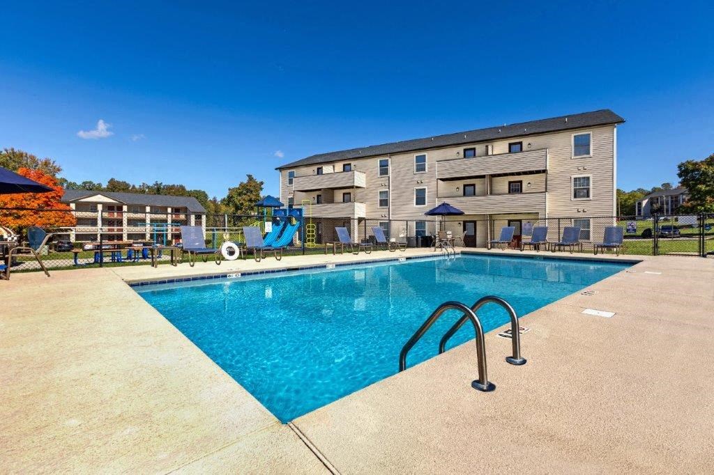 a swimming pool with a building in the background
