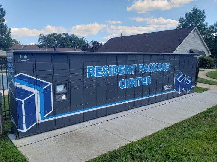 A blue and white painted shipping container is labeled as a resident package center.