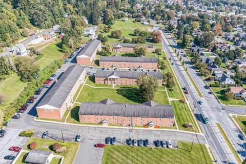 an aerial view of a large brick building from the sky
