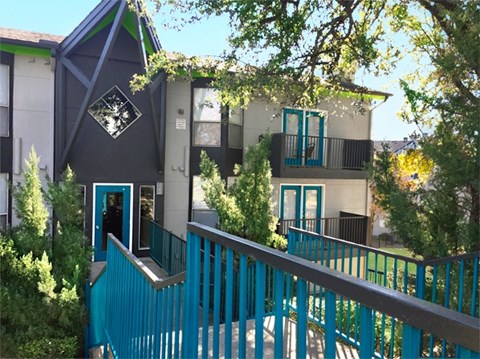 A blue fence in front of a building.