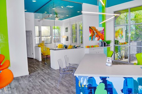 A brightly colored room with a white table and chairs.