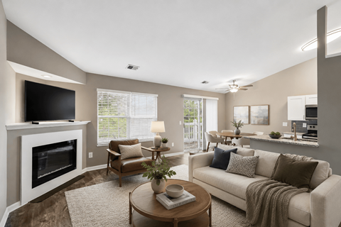 A living room with a fireplace, couch, and television.