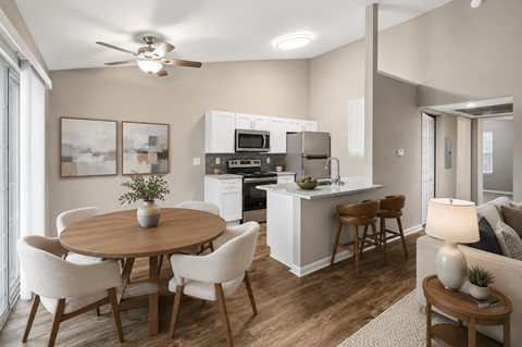A modern kitchen with a dining table and chairs.