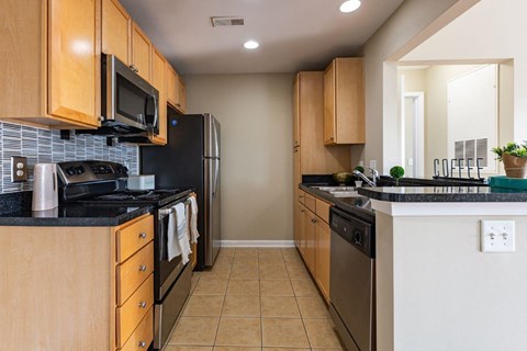 a kitchen with stainless steel appliances and wooden cabinets