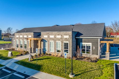 A building with a grey roof and a covered walkway.