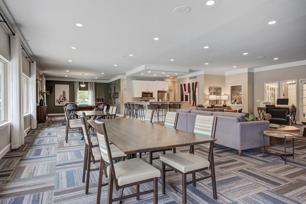a large dining room with tables and chairs and a living room