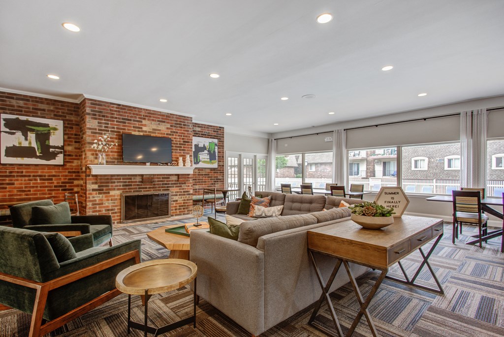 a living room with couches and chairs and a fireplace