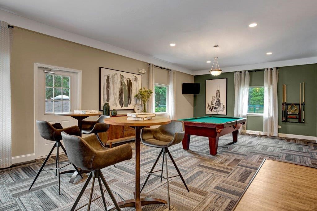 a game room with a pool table and a bar