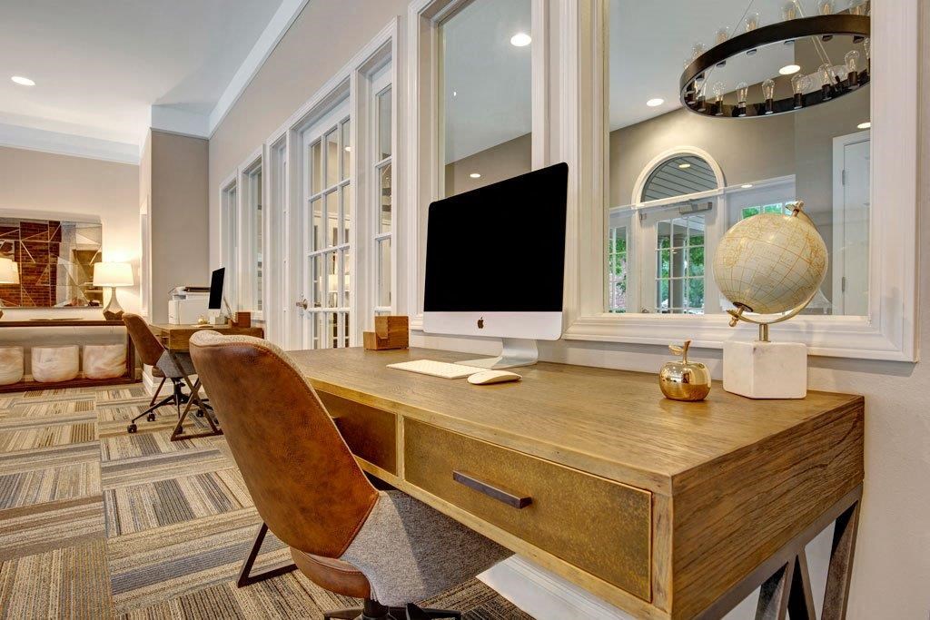 a home office with a desk and a monitor