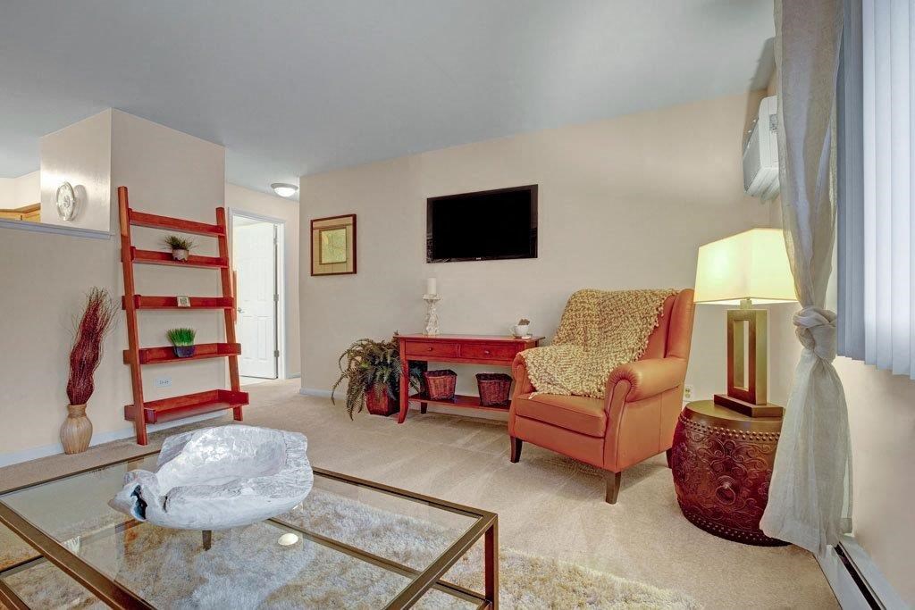 a living room filled with furniture and a flat screen tv